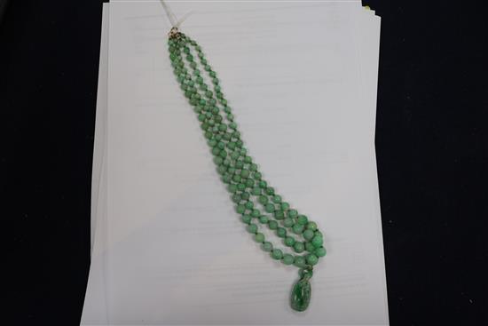 A double strand graduated jadeite bead necklace with carved jadeite pendant, pendant 29mm.